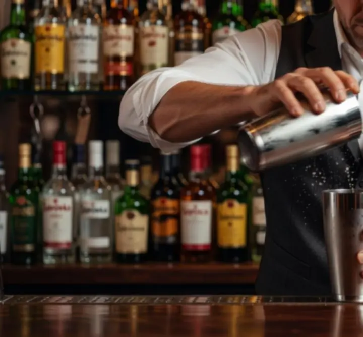 Profesjonalny barman STACKLURE przygotowujący koktajl za barem.